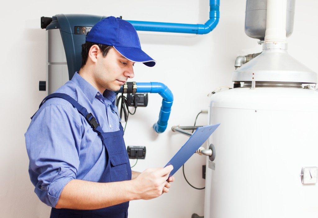 man fixing water heater