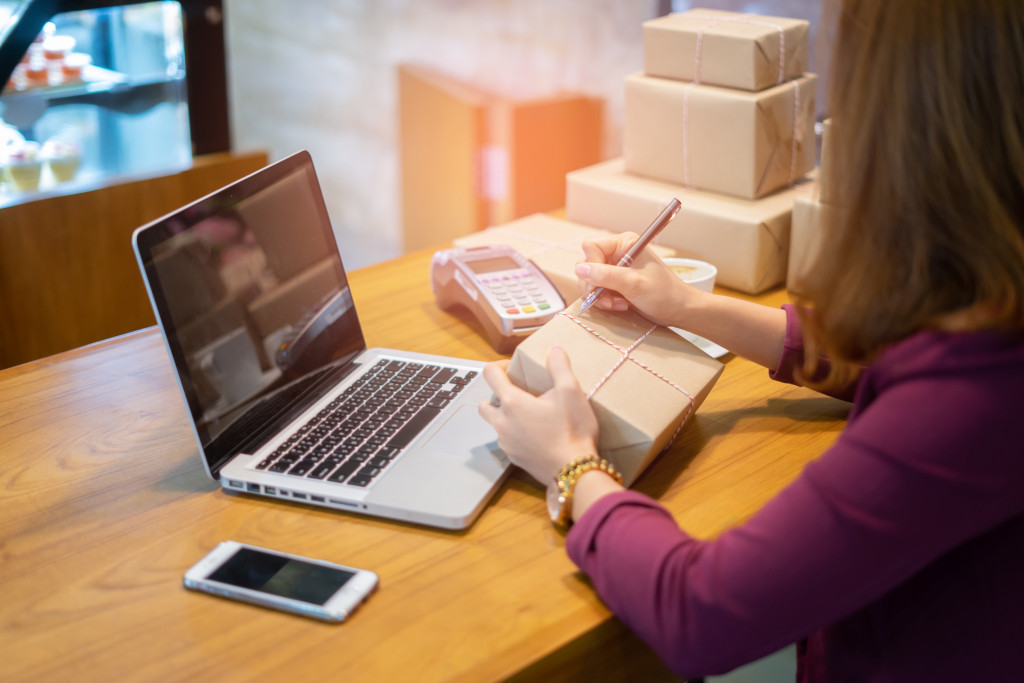 woman writing on a package