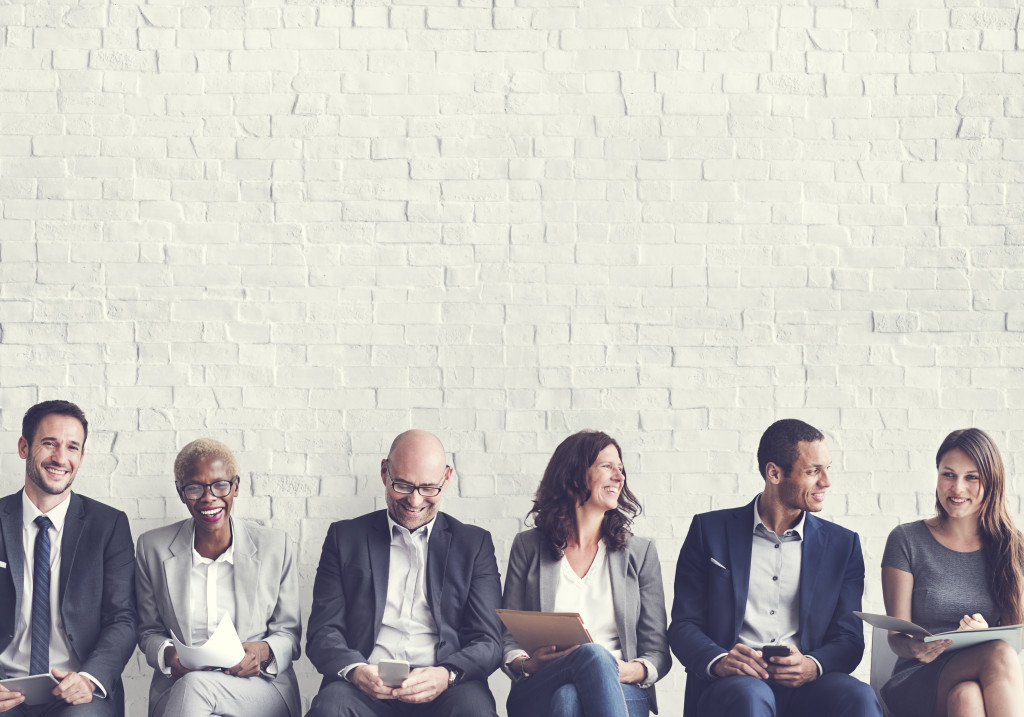 Interviewees sit in a row waiting for their turn