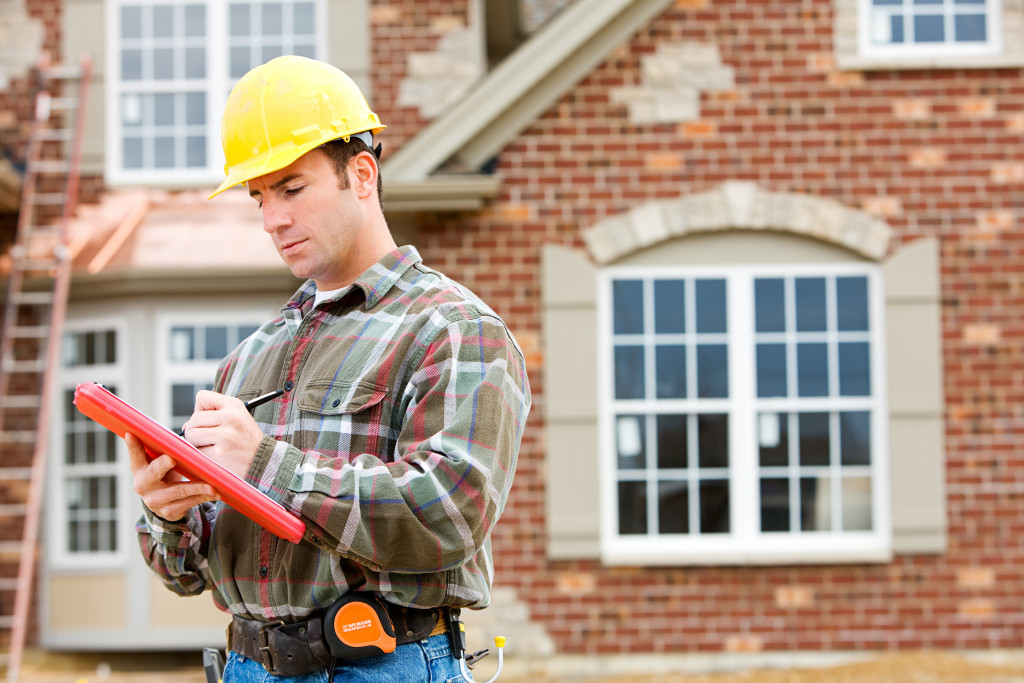 a home inspection taking notes in a construction project