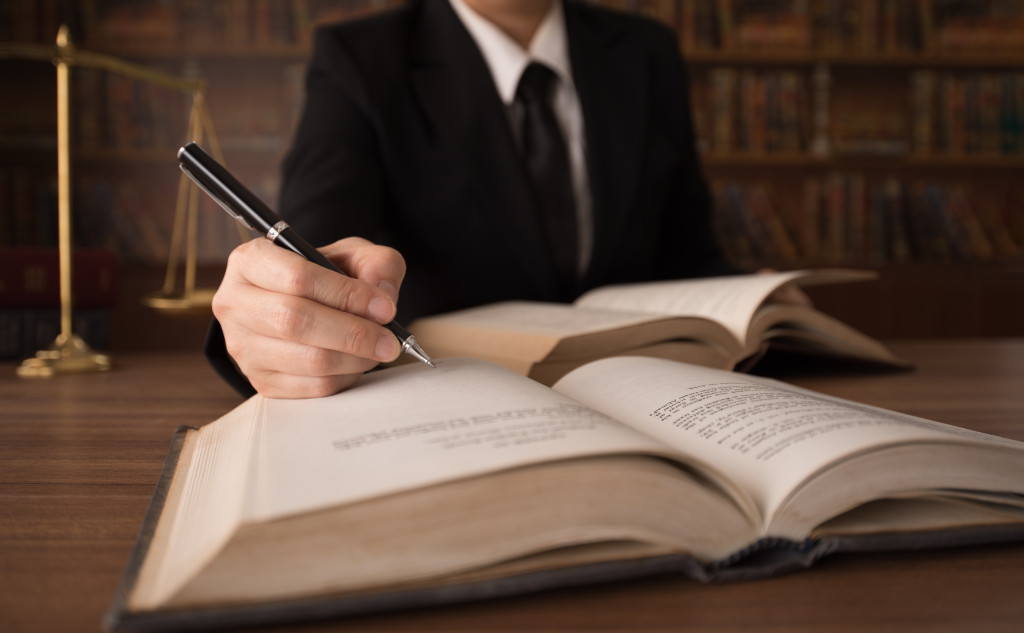 Lawyer checking the laws on a law book.