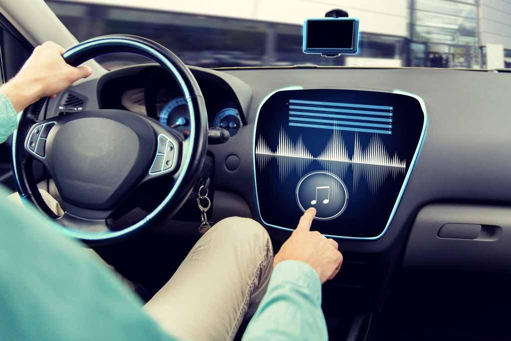 driver adjusting the music volume in the car