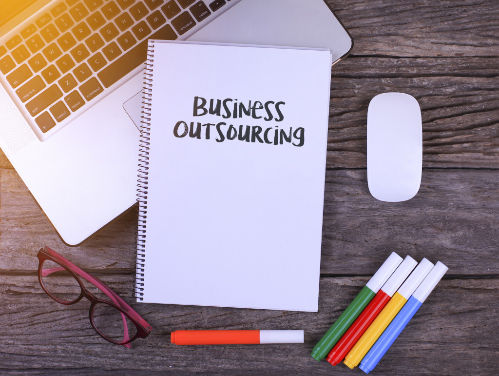 a notebook for business outsourcing plans